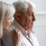 An older couple look towards the right