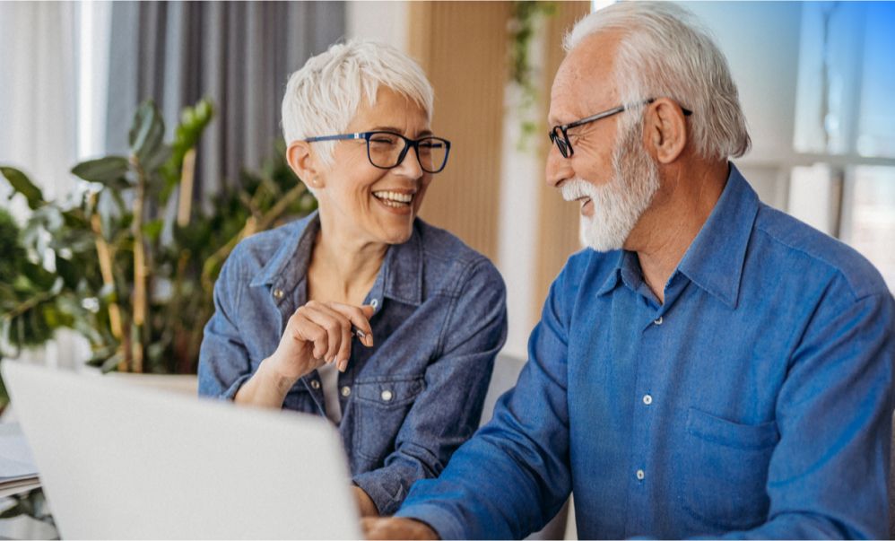 Older couple sitting at laptop together