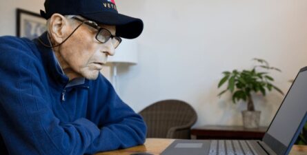 Elderly veteran looking at laptop