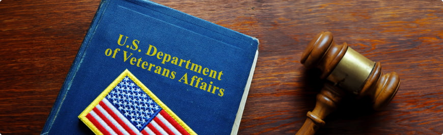 U.S. Department of Veterans Affairs VA book on a desk next to a gavel.